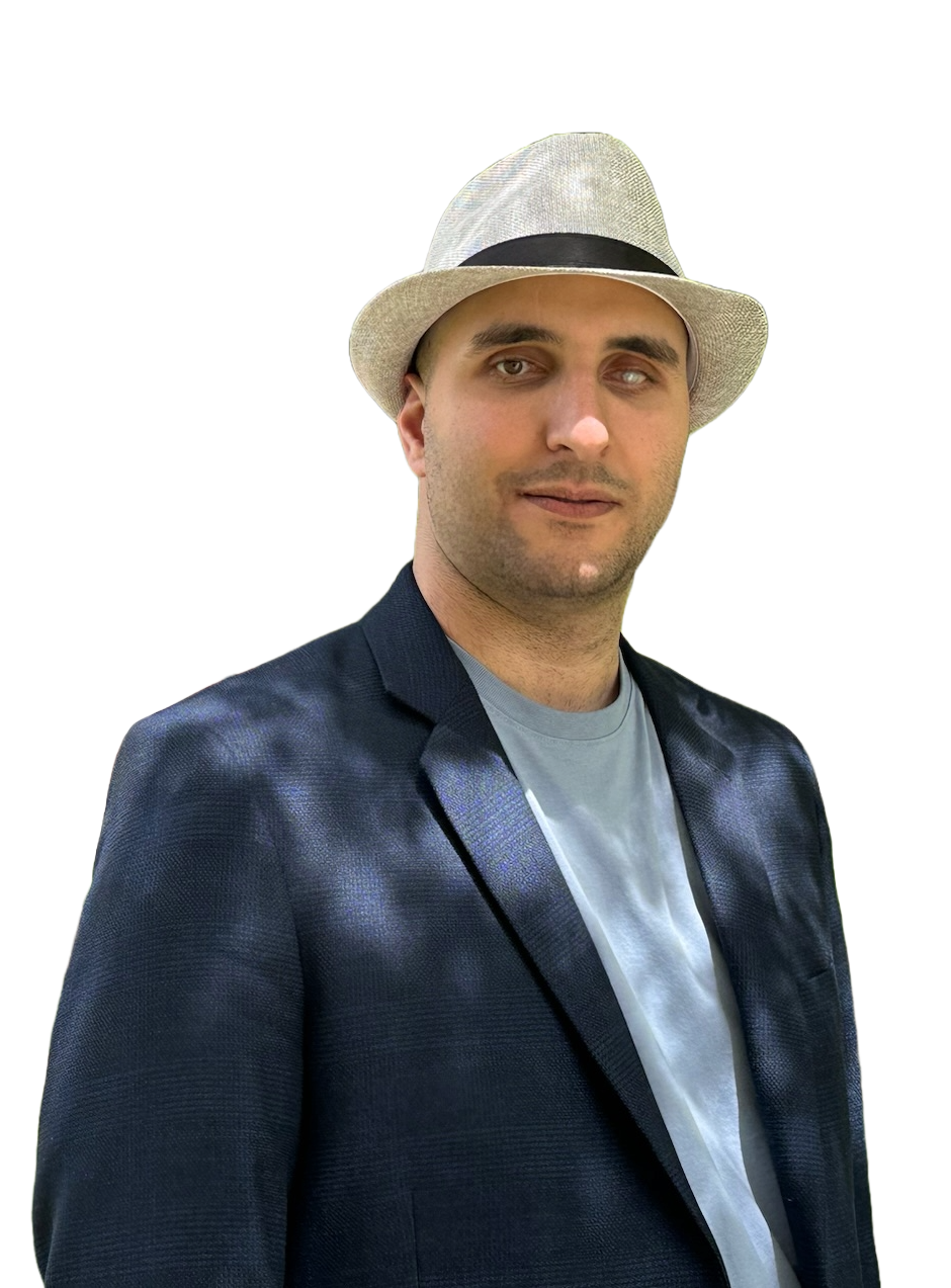 Aziz wearing a light grey fedora, navy blue blazer, and sky blue shirt.